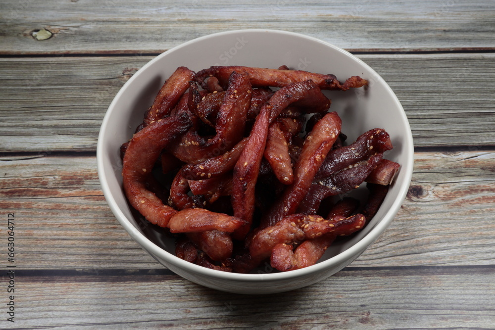 Pile of deep fried sliced salty pork serving in the bowl. Famous appetizer menu in Asian restaurant. Pile of deep fried sliced salty pork serving in the bowl. Famous appetizer menu in Asian restaurant.