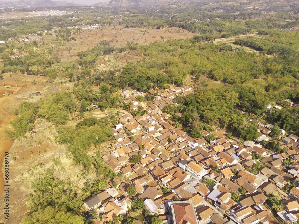 Bird's eye view of a developed residential area with cityscape and trees, Bojong Koneng - Bandung, Indonesia. Drone Photography, Aerial Photography, Landscape.