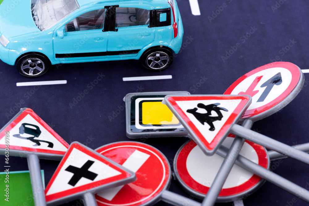 Obraz na plátně Ein Auto auf der Straße und verschiedene Verkehrsschilder