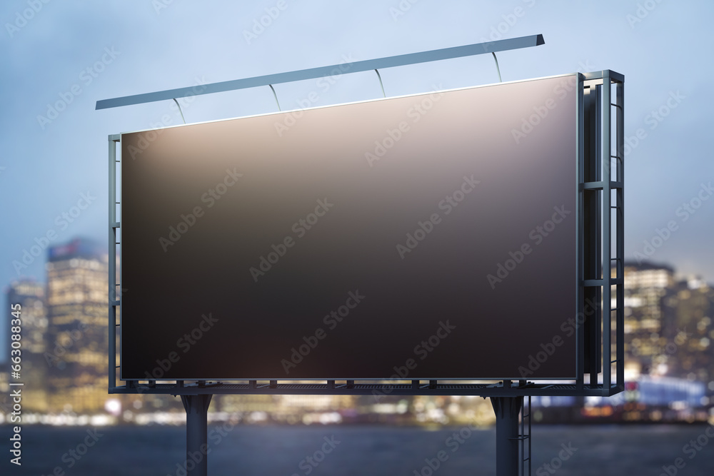 Blank black billboard on cityscape background at evening, perspective view. Mock up, advertising concept