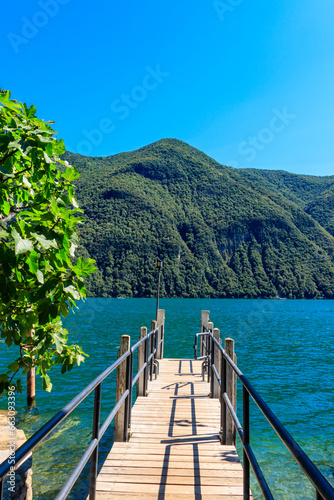 Wooden pier overlooking the Alps and Lake Lugano in Switzerland