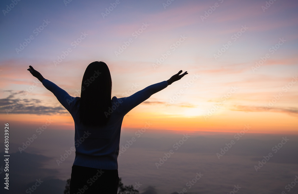 Silhouette of woman hand praying spirituality and religion, Woman raising his hands in worship. Christian Religion concept background.