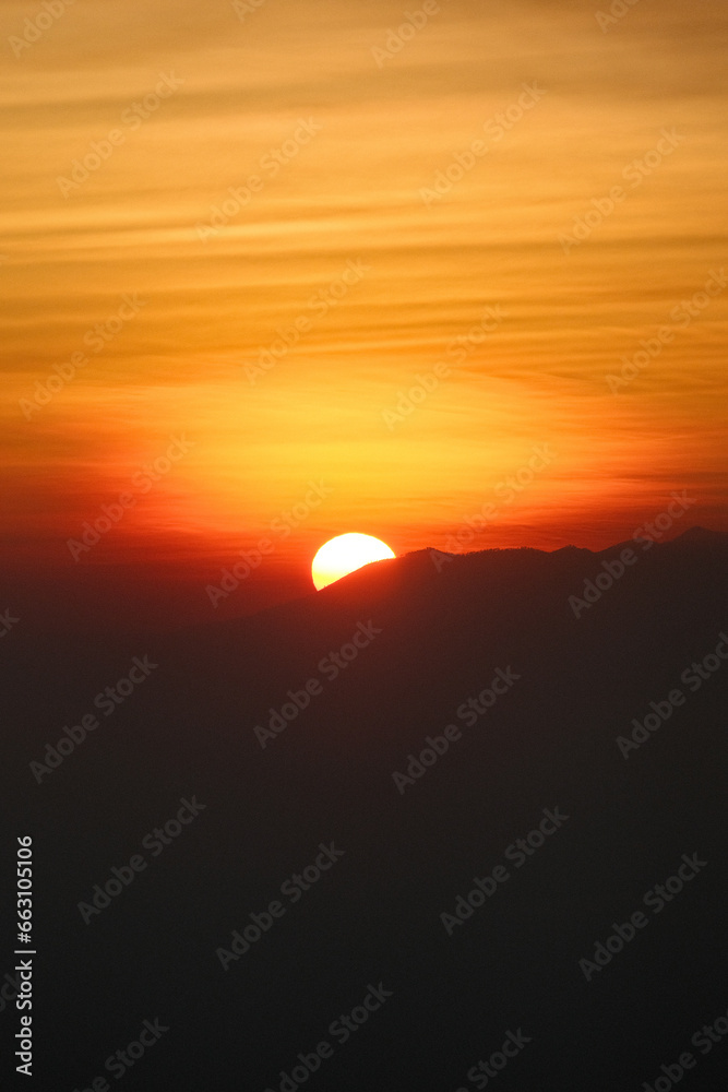 Half-Sunrise Majesty: Bromo's Half-Visible Sun in Vertical Splendor Half-Sunrise Majesty: Bromo's Half-Visible Sun in Vertical Splendor