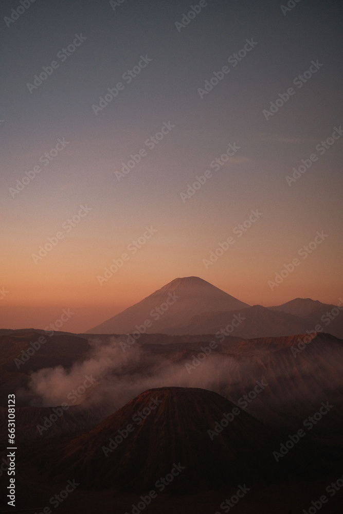 Vertical Elegance: Bromo's Sunrise in Warm Cloud Embrace Vertical Elegance: Bromo's Sunrise in Warm Cloud Embrace