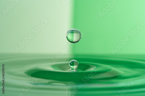 Group of colorful water droplets fall and bounce on a water surface
