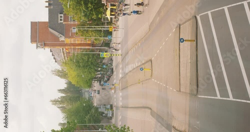 Vertical - Vehicles And Pedestrians On Bustling Street Of Zuidas In Amsterdam, Netherlands. Timelapse photo