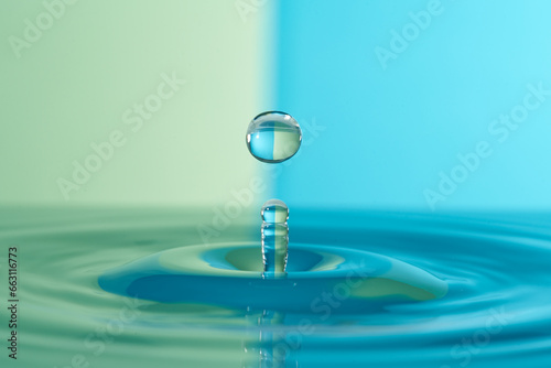 Group of colorful water droplets fall and bounce on a water surface