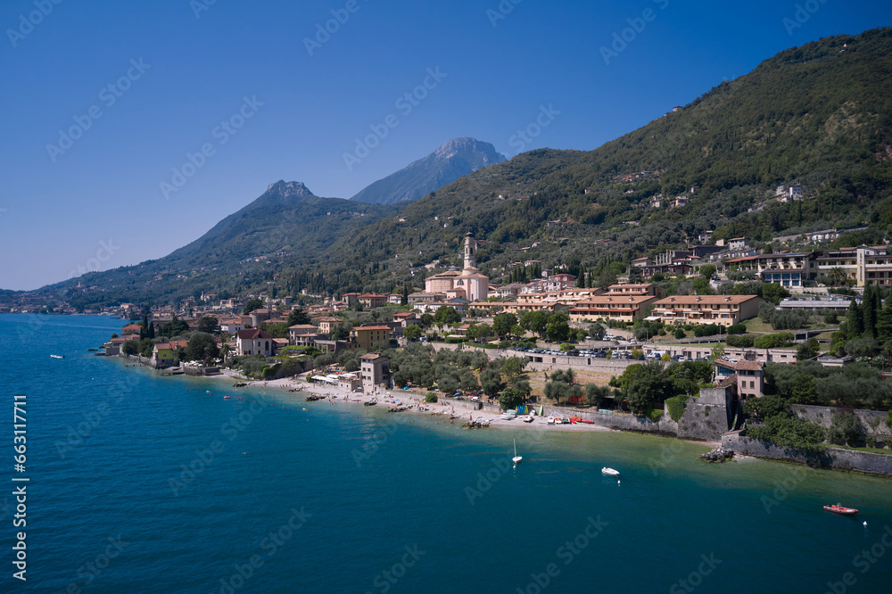 The city is located on the shores of Lake Garda. Panoramic aerial view of the city of Gargnano located on Lake Garda Italy. Coastline of the resort town of Gargnano Lake Garda Italy.