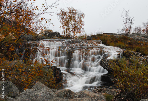 Autumn landscape with a waterfall in the Finland, Lapland