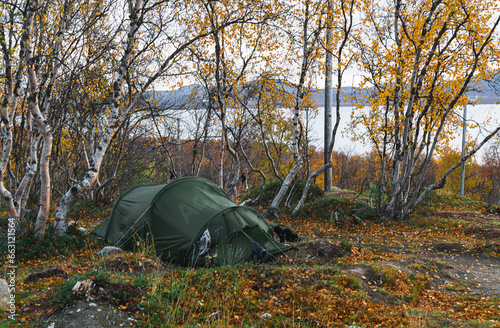 Camping on the bank of the lake in the autumn forest in Kilpisjarvi