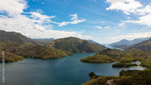 Top view of Lake among the mountains against the blue sky and clouds. Randenigala reservoir, Sri Lanka.