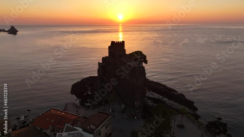 Aci Castello e sullo sfondo le isole Ciclopi di Acitrezza. Sicilia, Italia, 
Vista aerea all'alba della costa vulcanica siciliana tra Aci Castello e Acitrezza. photo