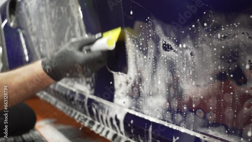 Installation of a protective paint and varnish transparent film on the car. PPF polyurethane film to protect the car paint from stones and scratches. Car detailing. 