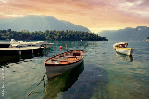 Fototapeta Naklejka Na Ścianę i Meble -  Beautiful scene of boats on lake Como in Italy. A big blue lake surrounded by green hills