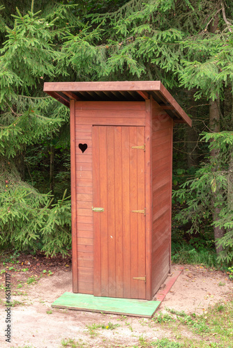 Forest hut or wooden toilet with a heart-shaped ornament in the middle of the forest © Photo by ERIKS ROZE