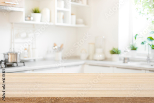 Wooden table top view for product montage over blurred kitchen interior background photo