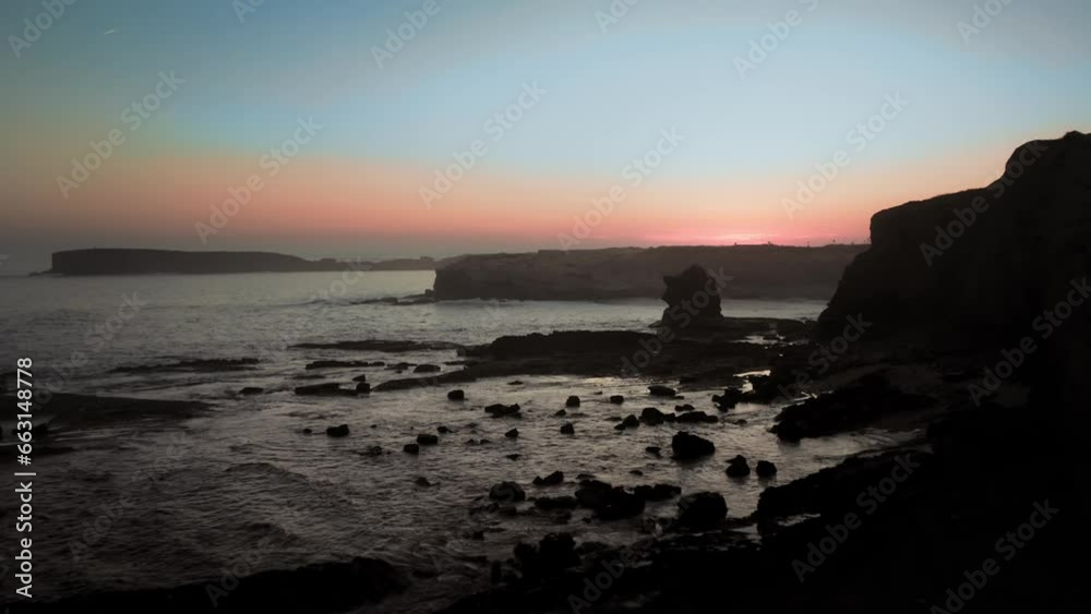 Drone shot of cliffs and rock formations at the shore with a coastal house in the background Drone shot of cliffs and rock formations at the shore with a coastal house in the background