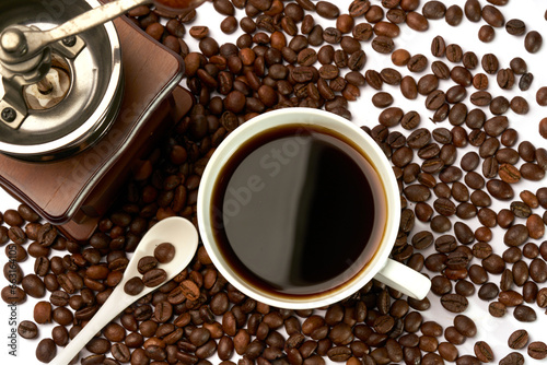 Black coffee and coffee beans on white background © shengyi