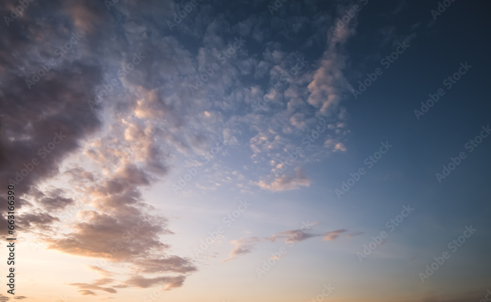 Minimalistic evening sky with clouds and sun glare, looking up at the sky in the evening