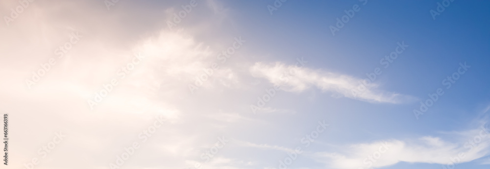 Atmospheric minimalistic summer sky with clouds and sun, bright sky in nature