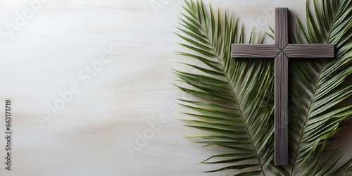 Palm Sunday Holiday. Wooden cross with palm leaf on light background with copy space. photo