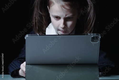 Lack of sleep as result of studying at night may impair children's mood, increase stress and anxiety levels and decreased cognitive abilities. Portrait of young girl studies at night.
