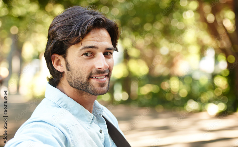 Relax, portrait or happy man in nature on a bench in summer for holiday vacation or break in garden. Freedom, smile or face of person in park resting or waiting in a natural environment for wellness Relax, portrait or happy man in nature on a bench in summer for holiday vacation or break in garden. Freedom, smile or face of person in park resting or waiting in a natural environment for wellness