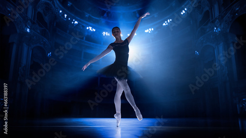 Training before performance. Young woman, elegant ballet dancer in motion, dancing on theater stage with spotlights. Concept of classical dance, art and grace, beauty, choreography, inspiration © master1305