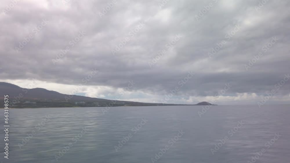 Gimbal wide panning POV shot from a moving boat of Haleakala and Wailea from Molokini Crater on the island of Maui, Hawai'i. 4K Gimbal wide panning POV shot from a moving boat of Haleakala and Wailea from Molokini Crater on the island of Maui, Hawai'i. 4K