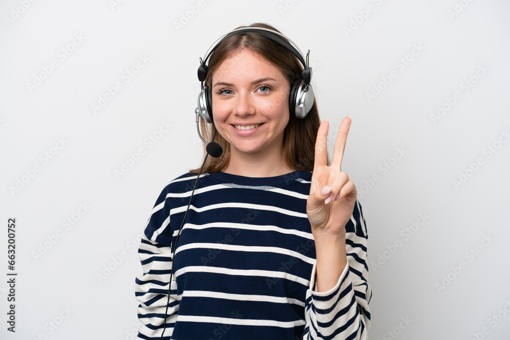 Telemarketer caucasian woman working with a headset isolated on white background smiling and showing victory sign Telemarketer caucasian woman working with a headset isolated on white background smiling and showing victory sign