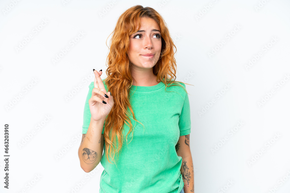 Young caucasian woman isolated on white background with fingers crossing and wishing the best Young caucasian woman isolated on white background with fingers crossing and wishing the best