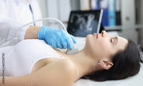 Obraz na płótnie Portrait of ultrasound scanning diagnostic of woman thyroid gland in clinic, doctor runs ultrasound sensor over patients neck with gel. Diagnostics concept w salonie