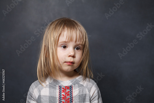 Portrait of beautiful child girl on blackboard background