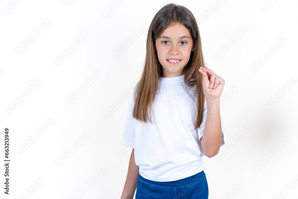 Beautiful kid girl wearing white T-shirt pointing up with hand showing up seven fingers gesture in Chinese sign language QÄ«. Beautiful kid girl wearing white T-shirt pointing up with hand showing up seven fingers gesture in Chinese sign language QÄ«.