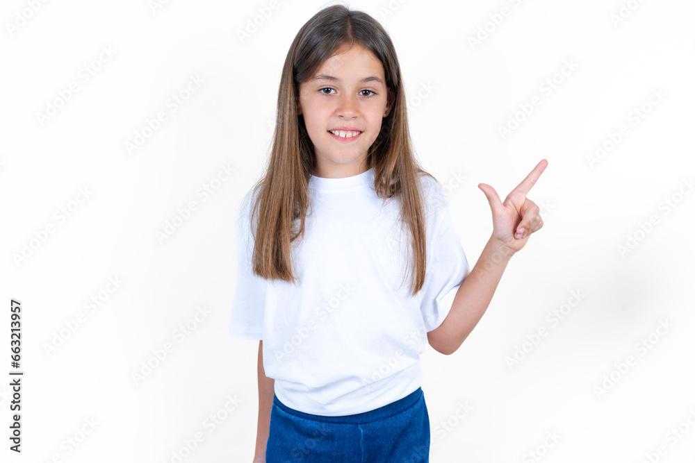 Beautiful kid girl wearing white T-shirt pointing up with fingers number eight in Chinese sign language BÄ. Beautiful kid girl wearing white T-shirt pointing up with fingers number eight in Chinese sign language BÄ.