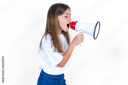 Beautiful kid girl wearing white T-shirt Through Megaphone with Available Copy Space