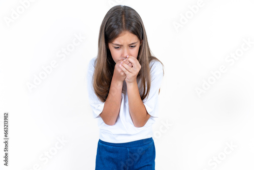 Beautiful kid girl wearing white T-shirt holding oneself, feels very cold outside, hopes that will not get cold photo