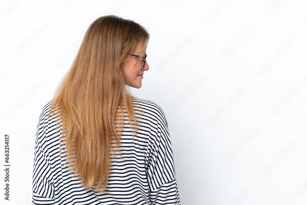 Young caucasian woman isolated on white background in back position and looking side Young caucasian woman isolated on white background in back position and looking side