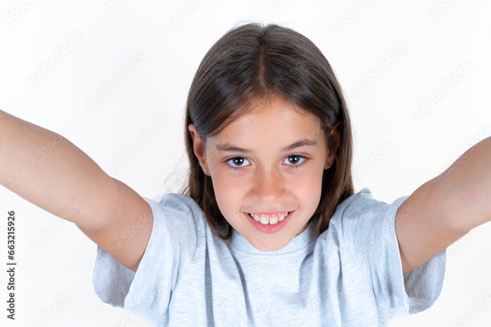 Photo of Beautiful little kid girl wearing blue T-shirt do selfie Photo of Beautiful little kid girl wearing blue T-shirt do selfie