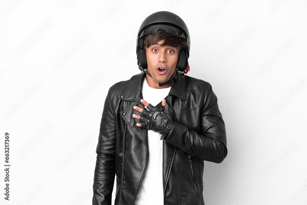 Young man with a motorcycle helmet isolated on white background surprised and shocked while looking right Young man with a motorcycle helmet isolated on white background surprised and shocked while looking right