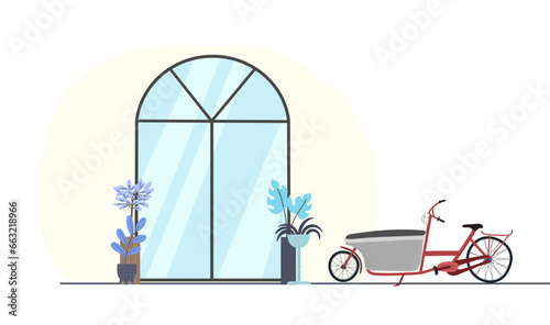 Cargo bike, bakfiets in a parking sight near the glass front door of a house, hotel, shop, restaurant. Exterior view of hallway from street.