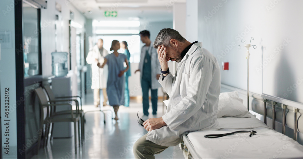 Depression, grief or fail with a mature doctor in a hospital looking unhappy for healthcare or medical. Stress, mistake or loss with a sad man medicine professional in a professional medicare clinic - obrazy, fototapety, plakaty 