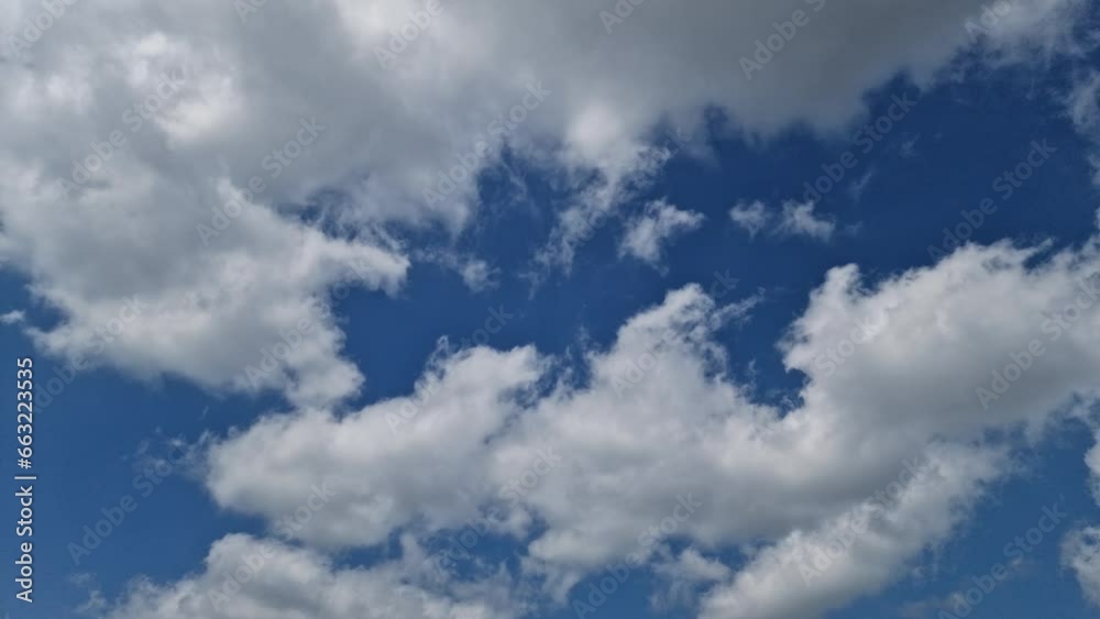 white clouds moving across the sky. blue sky background. 4K. time lapse