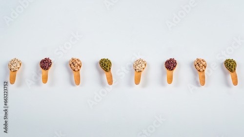 Mung beans, Red kidney beans, Chickpeas source and peeled barley isolated on spoon wooden on white background