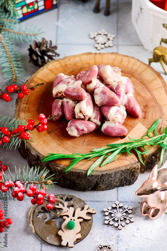 Raw chicken hearts prepared for Christmas dishes in a Christmas decor.