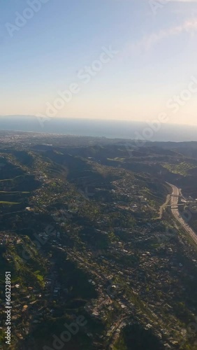 Wallpaper Mural Aerial view of ocean and mountains covered in clouds. Vacation and travel concept. The plane flies over the ocean. Vertical background, vertical video background, vertical video.  Torontodigital.ca