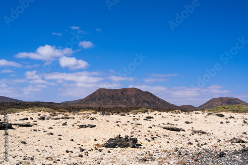 View of two volcanoes from one of the island's beaches. Photography taken in Fuerteventura, Canary Islands, Spain.
