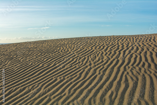 Landscape with sand pattern and blue sky