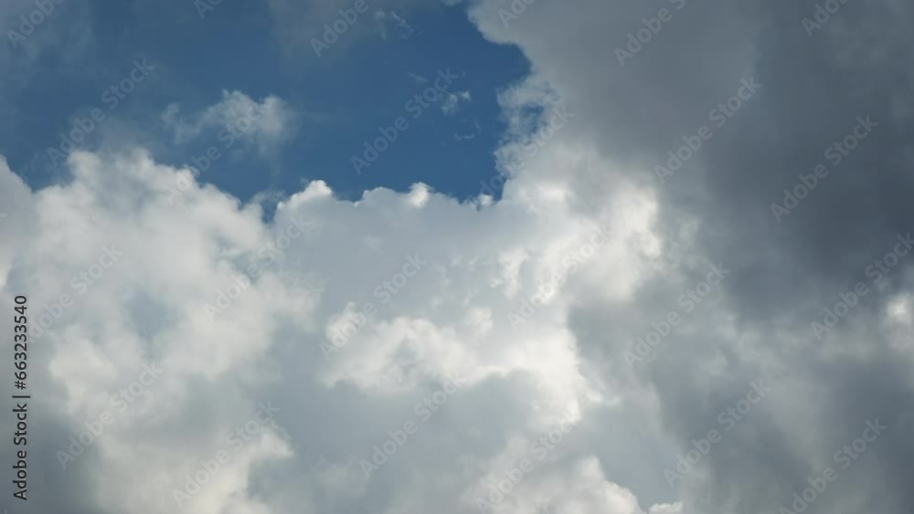 Summer clouds time lapse against blue sky and sun rays Summer clouds time lapse against blue sky and sun rays