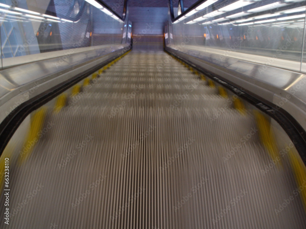 Top view, stairs and escalator in modern building for travel, moving and transport in airport. Metal, steel and closeup of electrical stairway in shopping mall, office or subway for urban commute